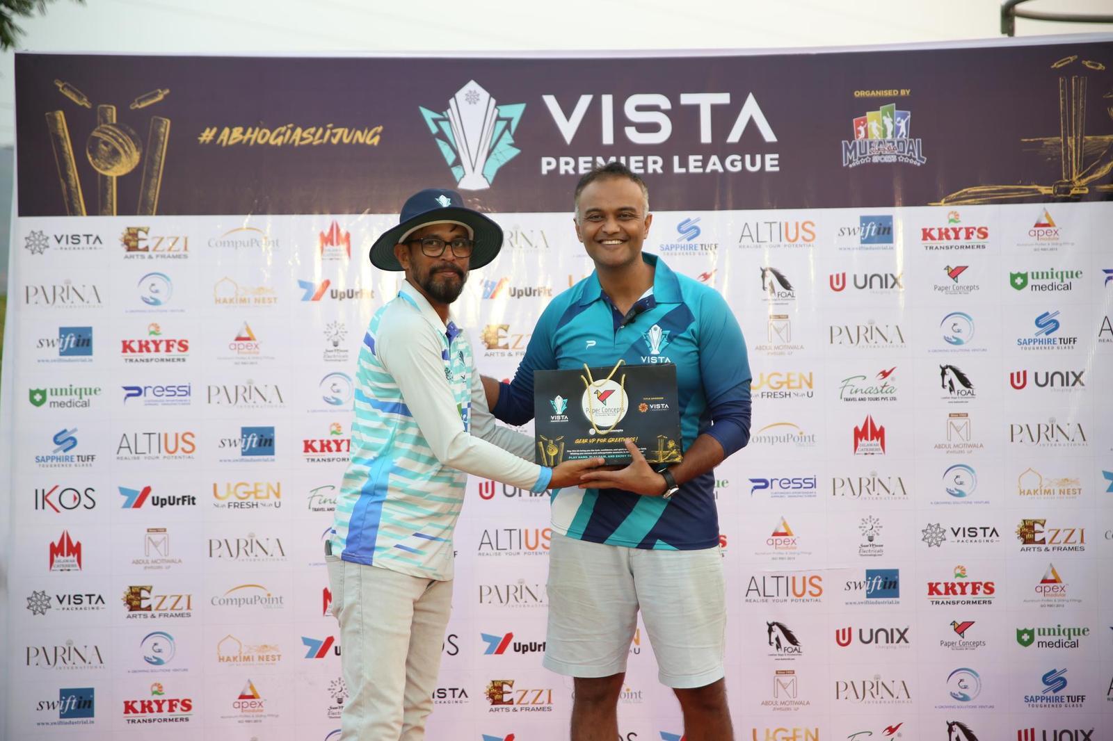Award presentation in front of the VPL sponsor wall